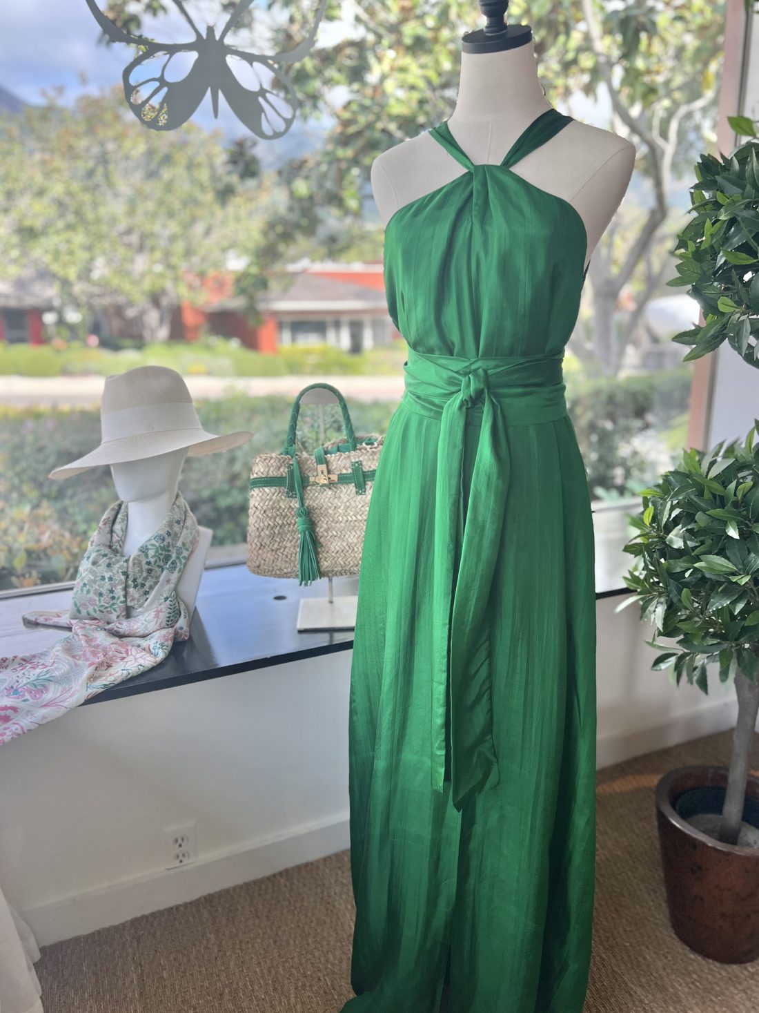 Emerald silk halter dress in the boutique window